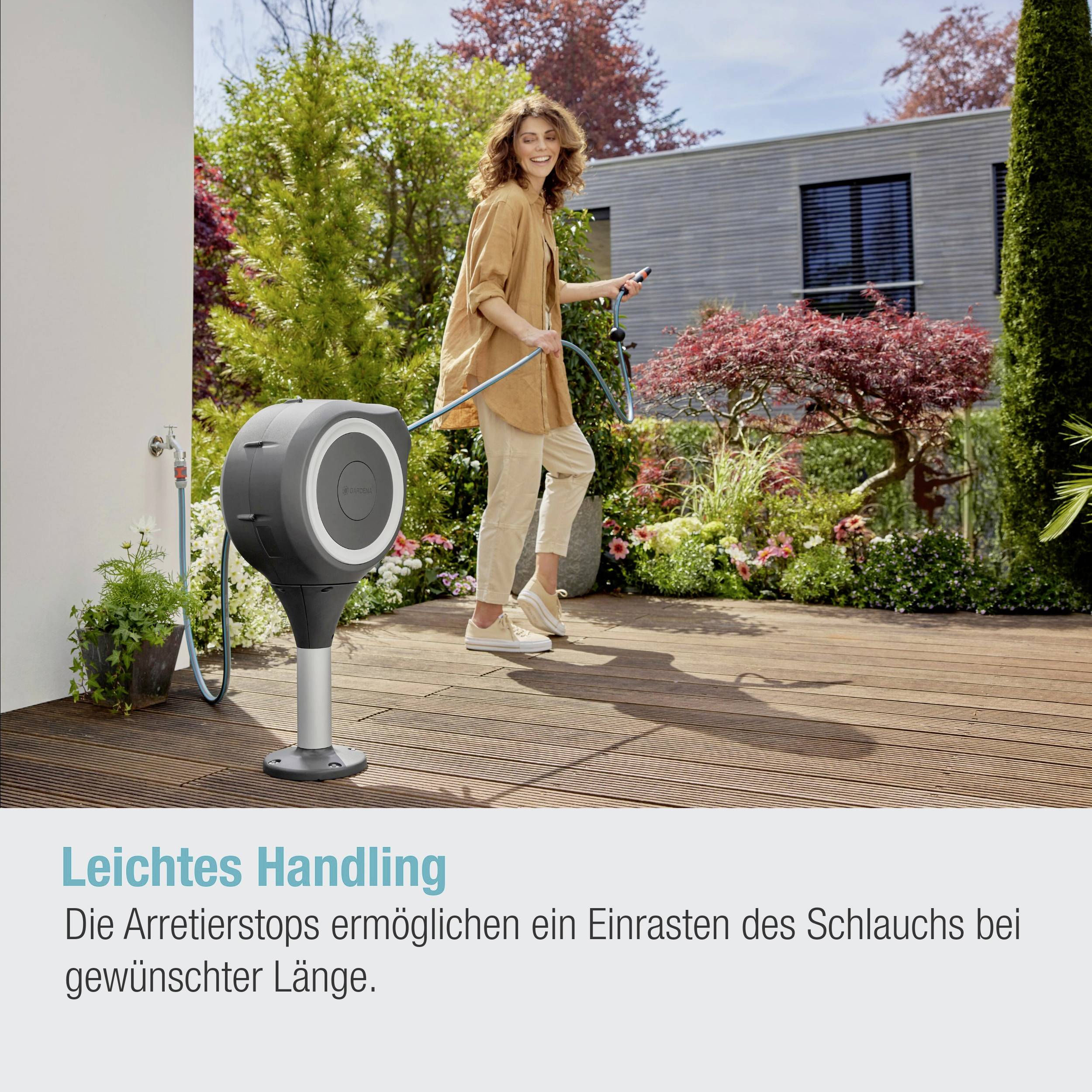 Woman in a garden pulling a garden hose from a hose reel. Text: 'Easy Handling'.