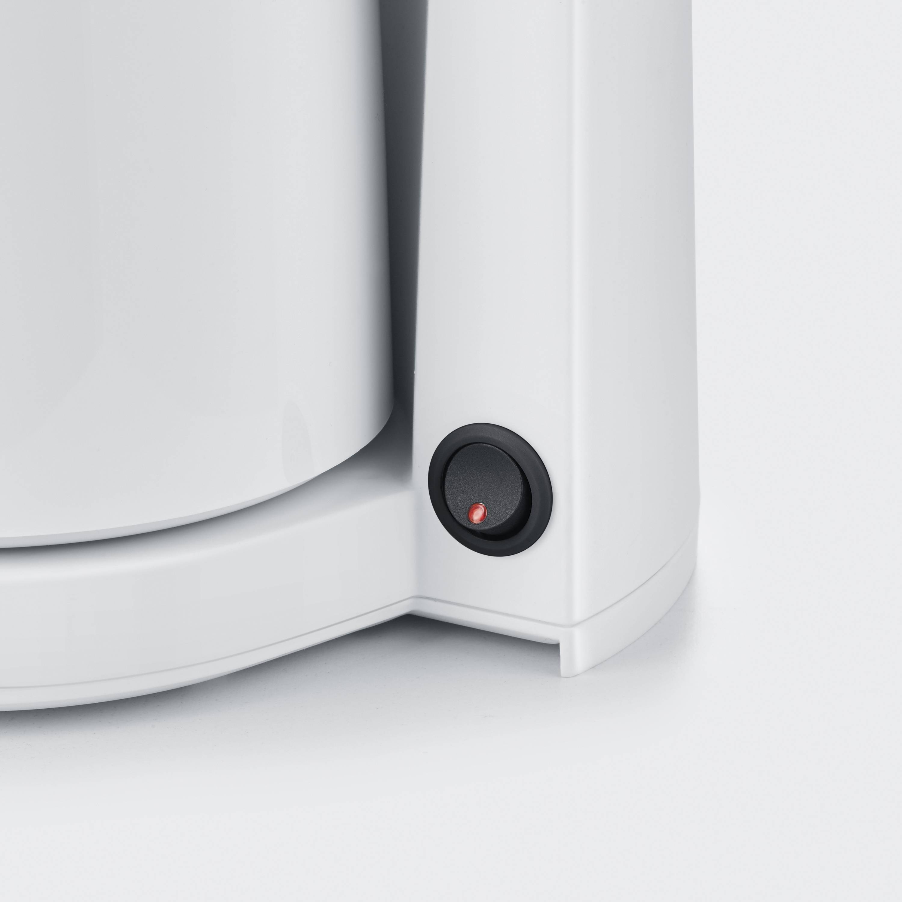 A white coffee machine with a red power switch on the side.