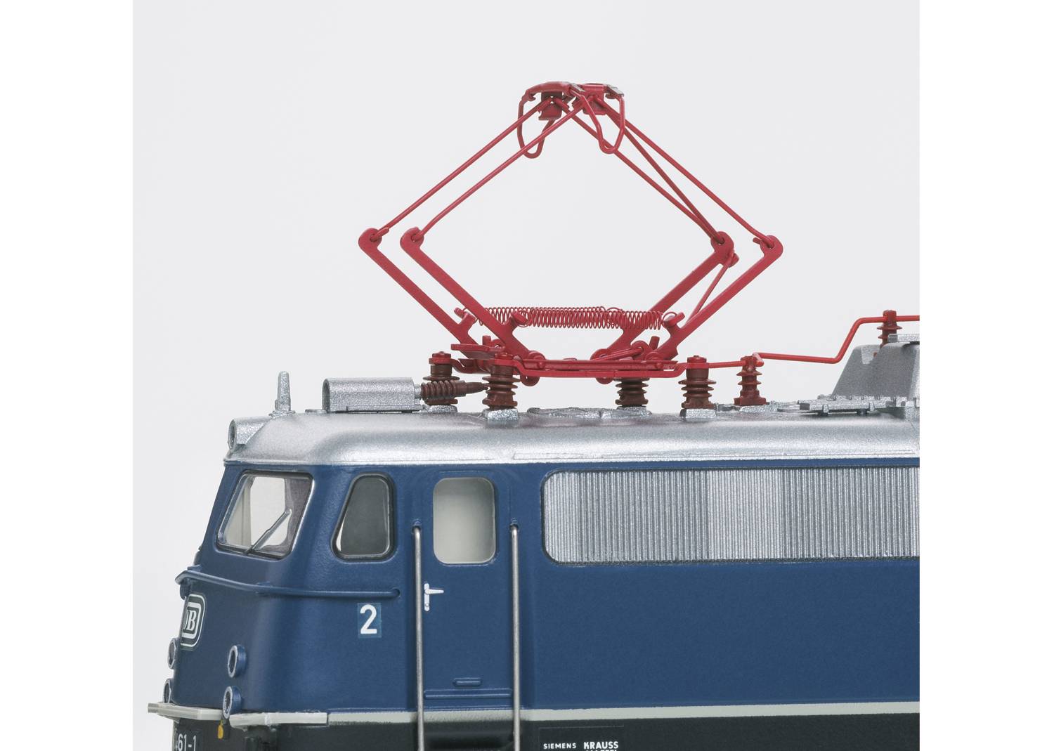 Blue train with pantograph on the roof. Front section of the locomotive visible. Electrical components are shown in detail.