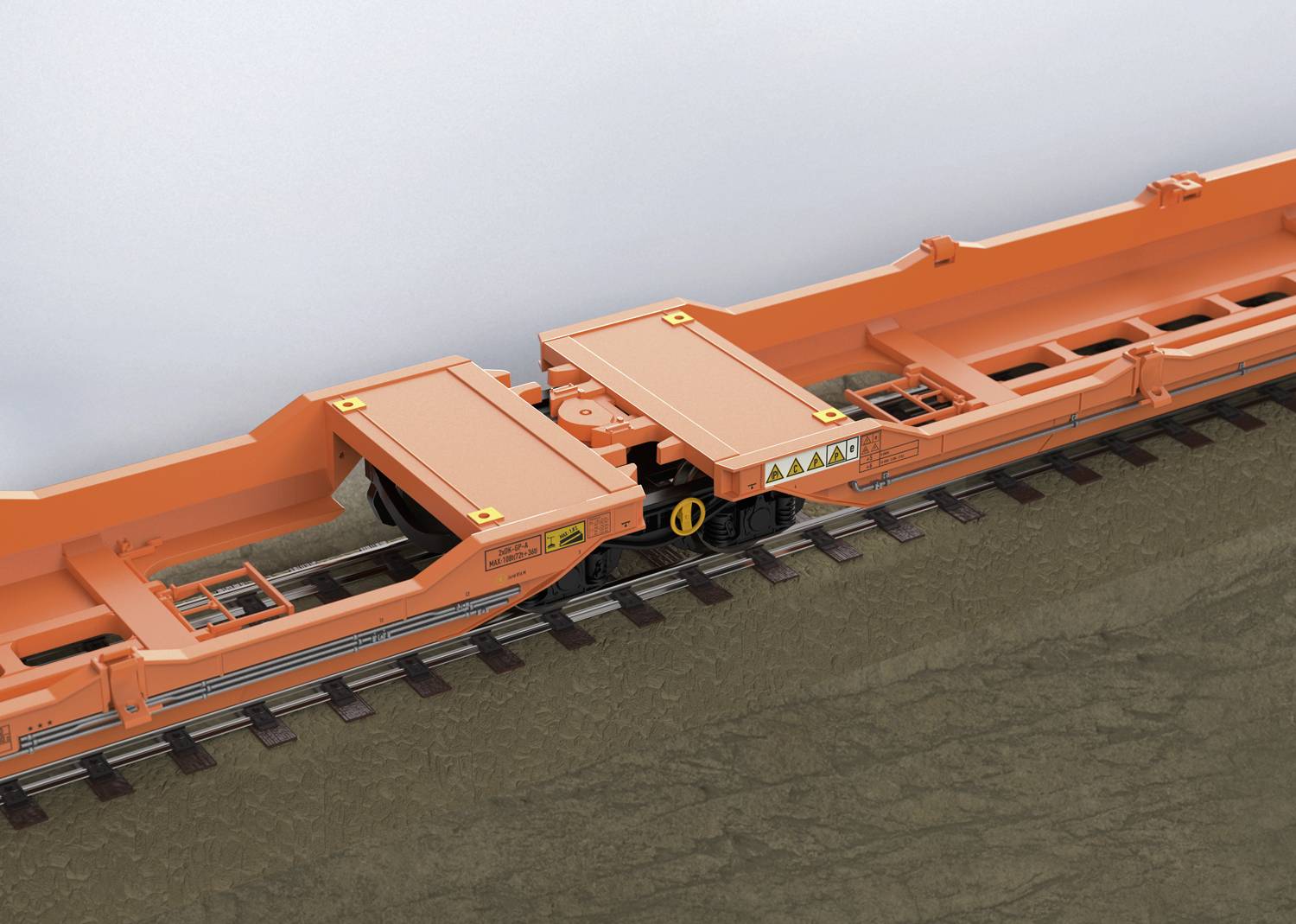 An orange railway freight wagon module with a lowered loading deck on tracks, suitable for transporting heavy goods.
