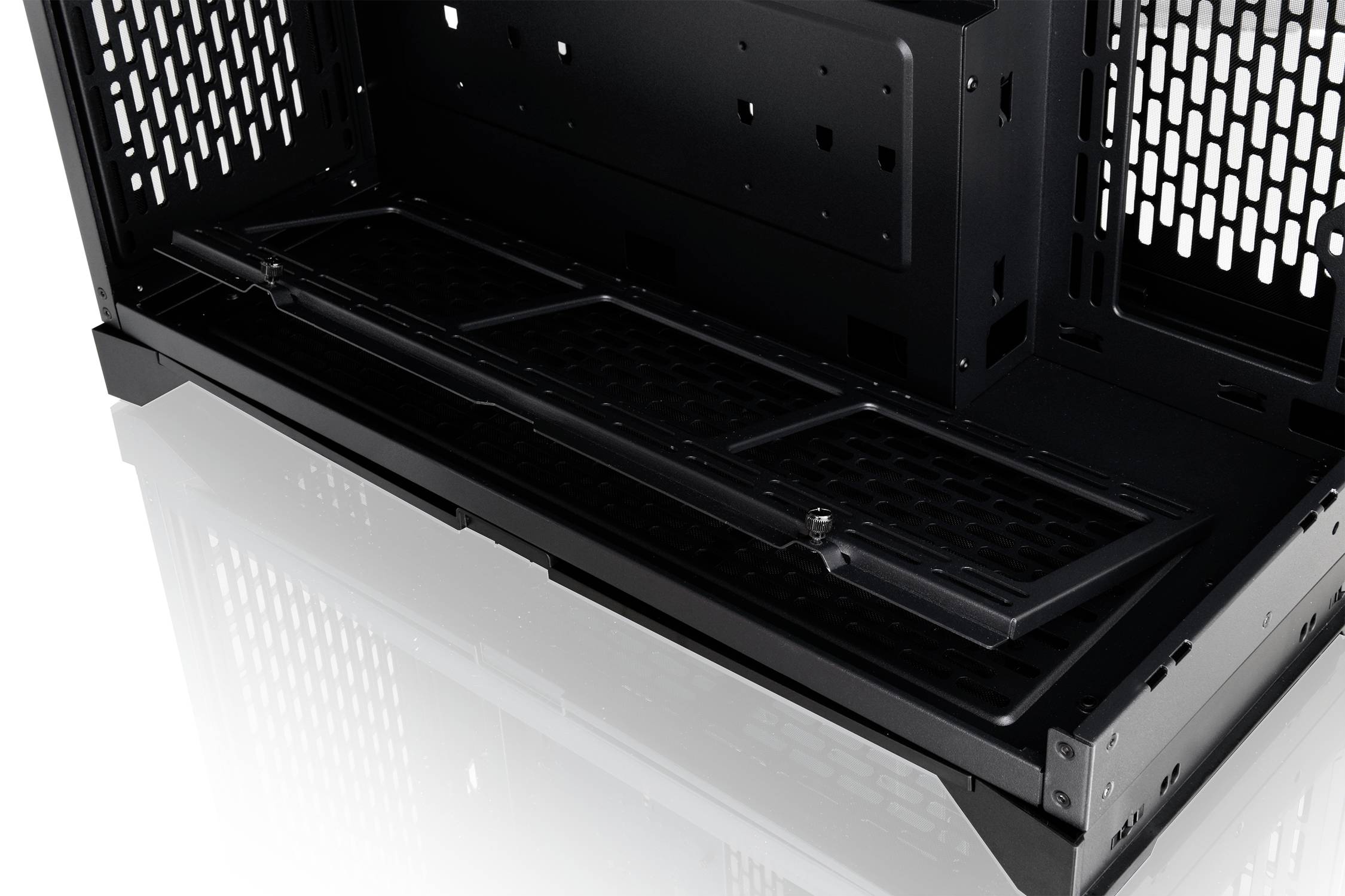 Interior of a computer case with a removable bottom filter designed to improve airflow and cooling.