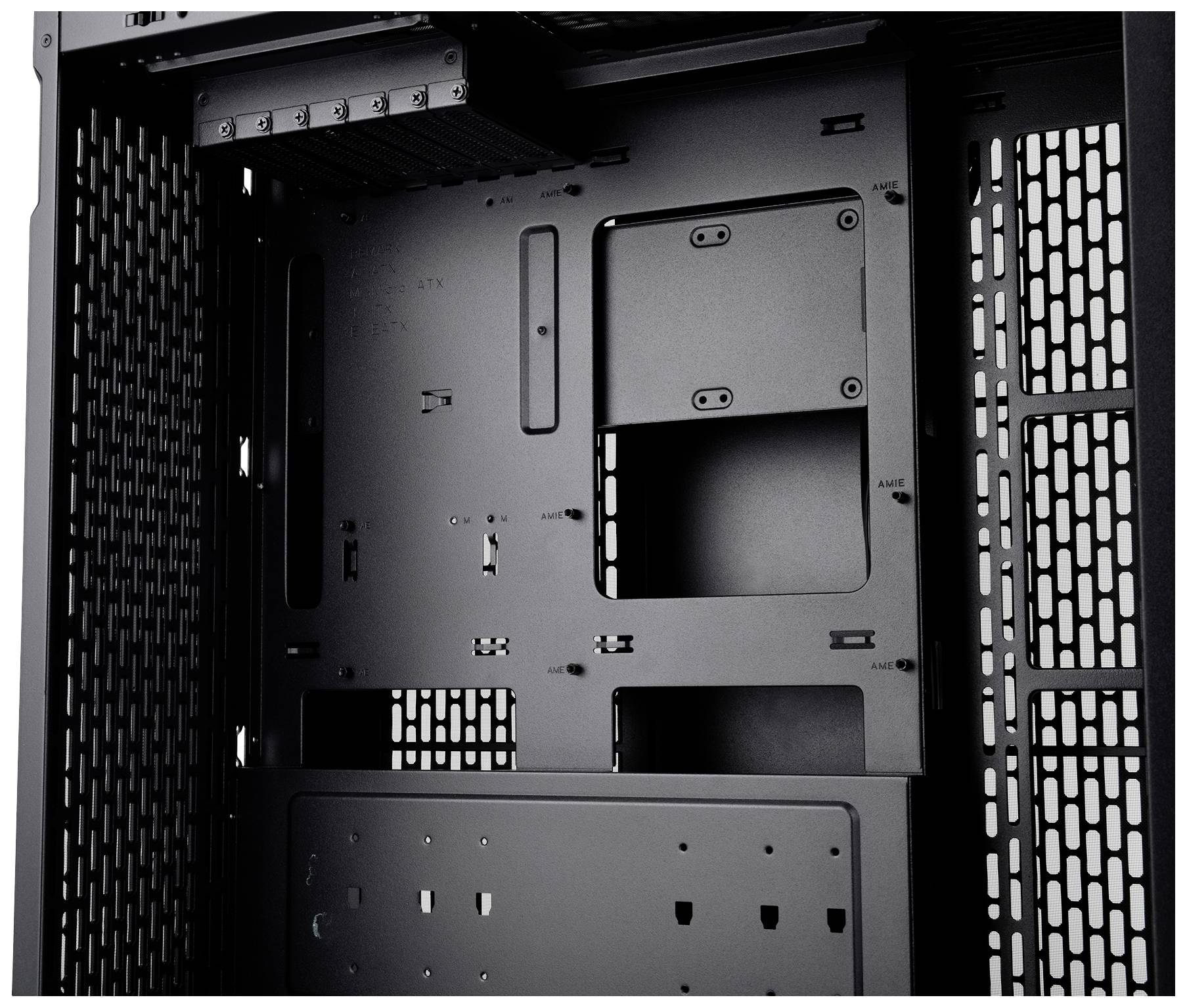 Empty interior of a computer case with open expansion slots and mesh for air circulation.