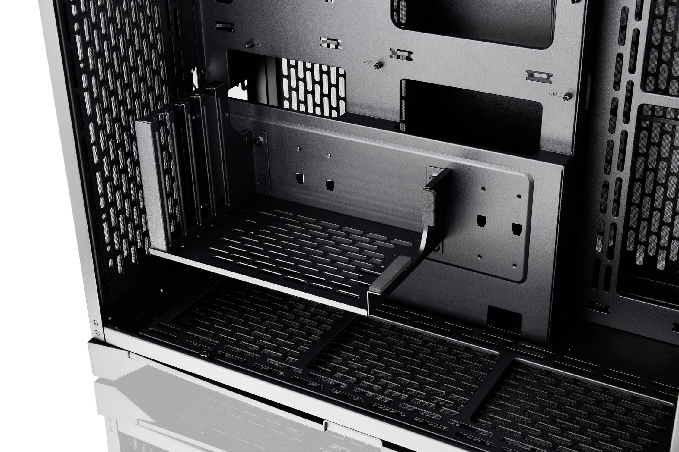 Interior view of a computer case with modular mounting brackets and ventilation slots for optimised air circulation and component positioning.