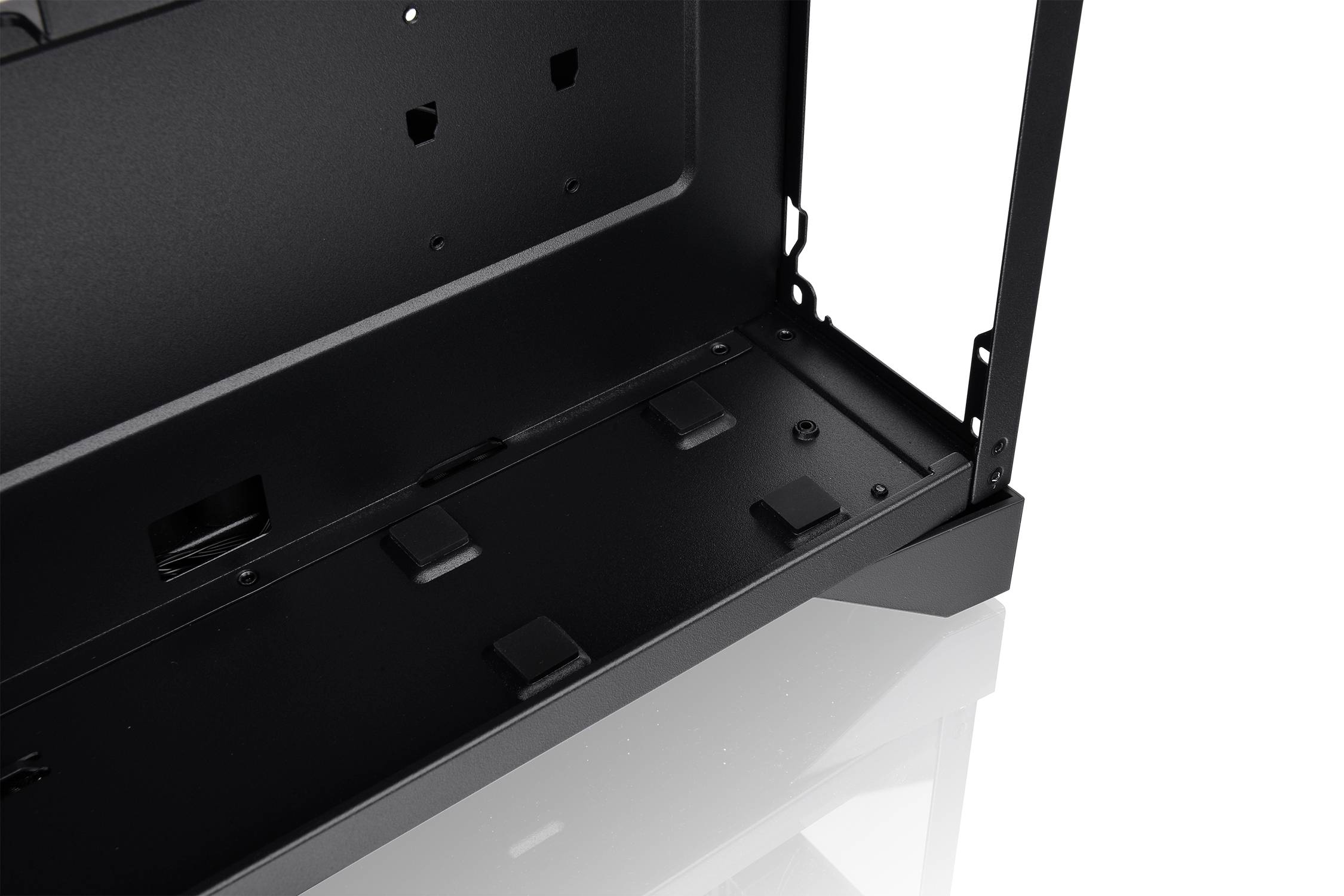 Interior view of a black computer case with open sides, visible mounting points, and cable management slots.