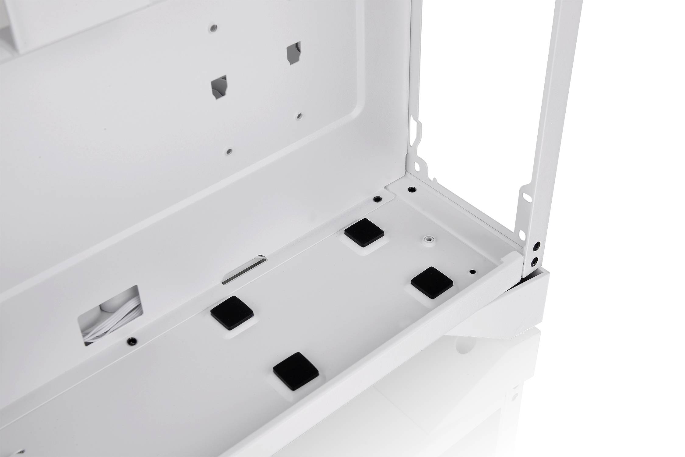 'Detailed view of a white housing with multiple ventilation openings and slots on the lower plate.'