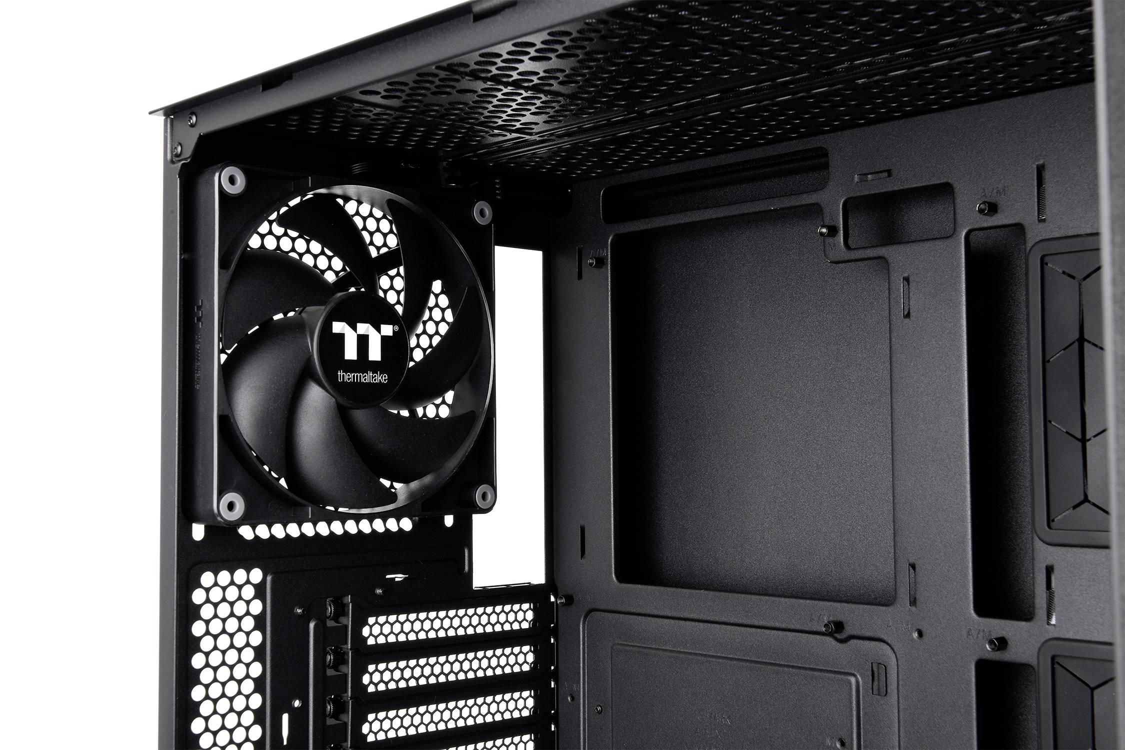 Interior view of an empty computer case with a built-in fan in the top left, numerous cutouts for hardware components visible.