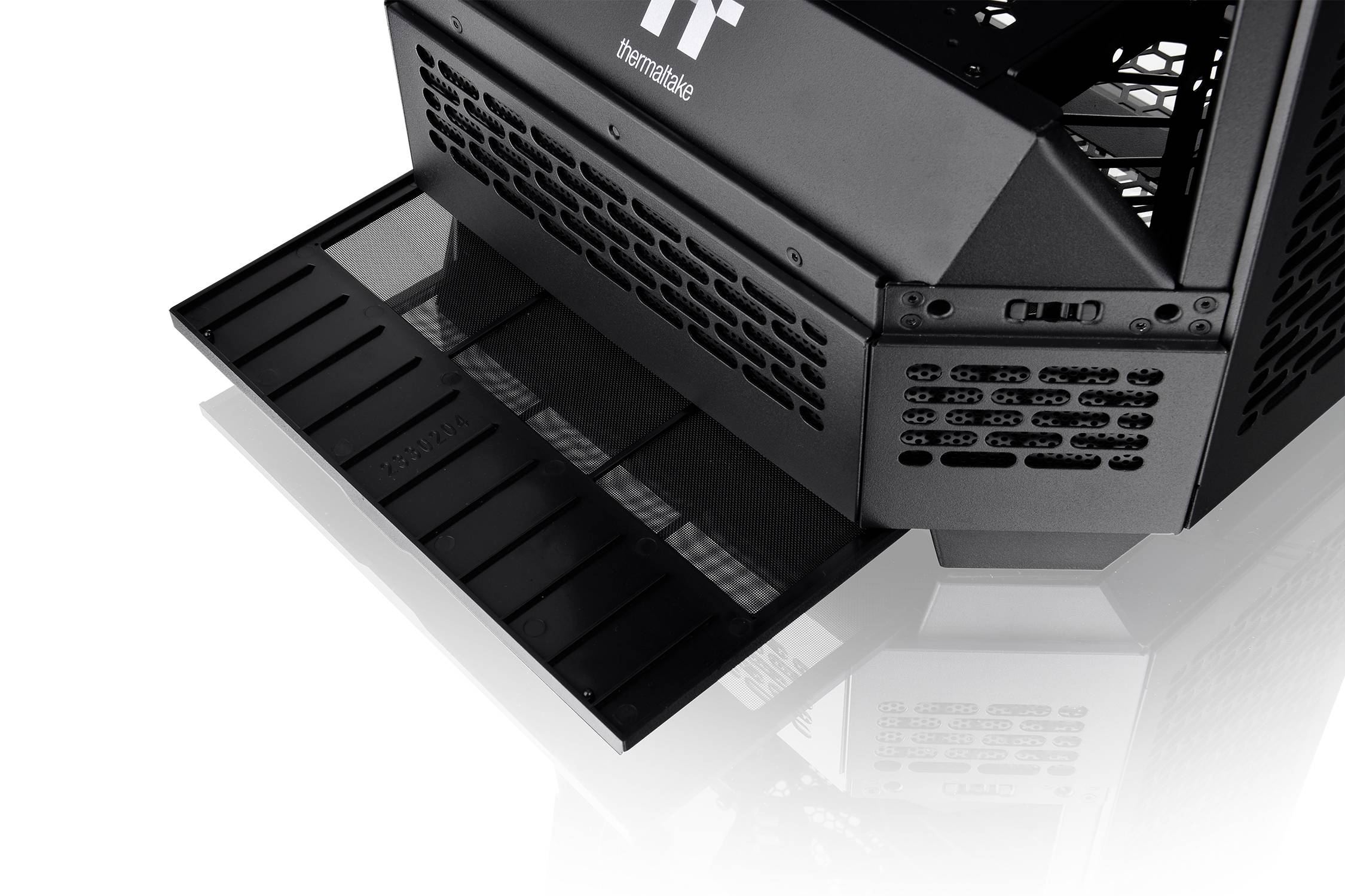 A black computer case ventilation filter that is open and removed. It has been taken out to clean the interior slightly or perform maintenance work.