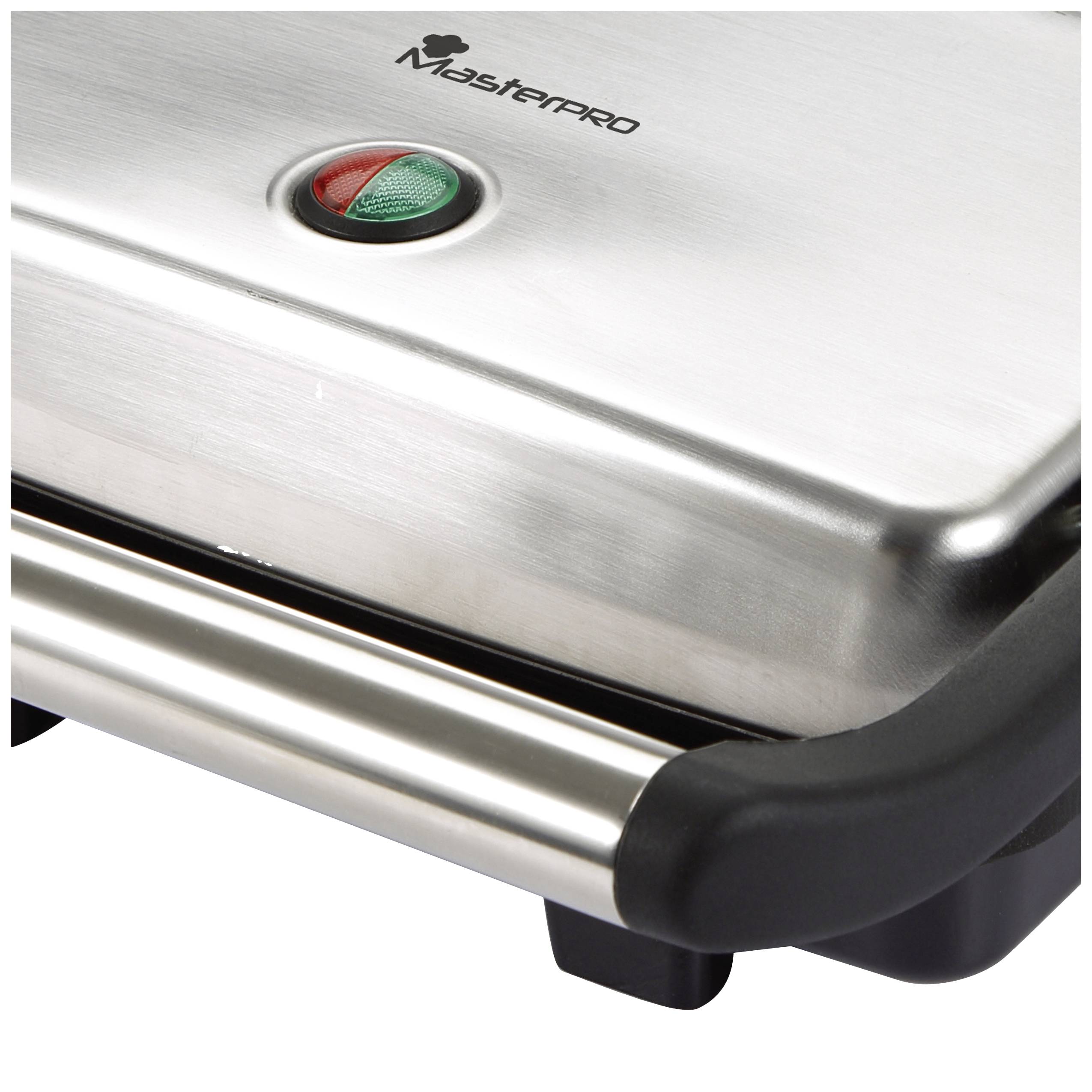 A silver barbecue with indicator lights on the top surface; a green and a red lamp.