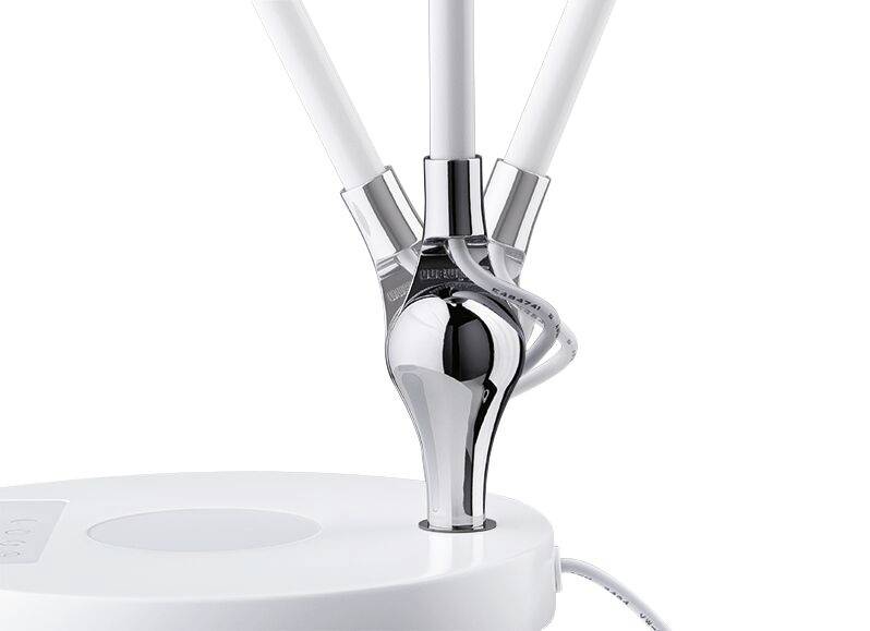 Modern table lamp with a slender, chrome-plated stand and white, illuminated tubes. Minimalist design on a white base.