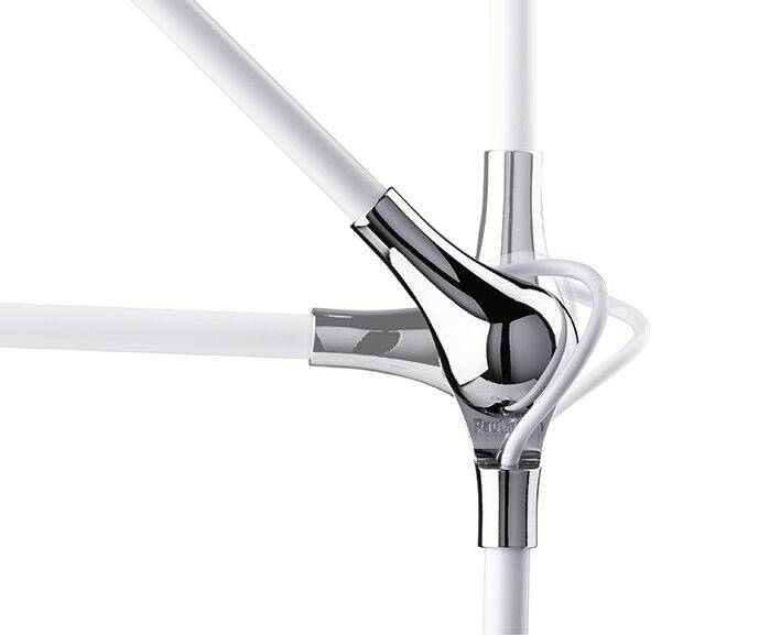 A chrome-plated pipe connector joining white pipes in a design object or piece of furniture.