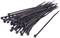 A bundle of black cable ties, stacked on a white surface.