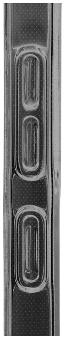 Close-up of a vertically positioned, rectangular object with structured edges and oval protrusions.
