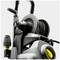 Pressure washer made of black and grey plastic with hose reel and nozzle holder. Main view focused on reel and handle.