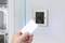 A person holds an access card in front of an electronic door lock with a green light, indicating a successful activation.