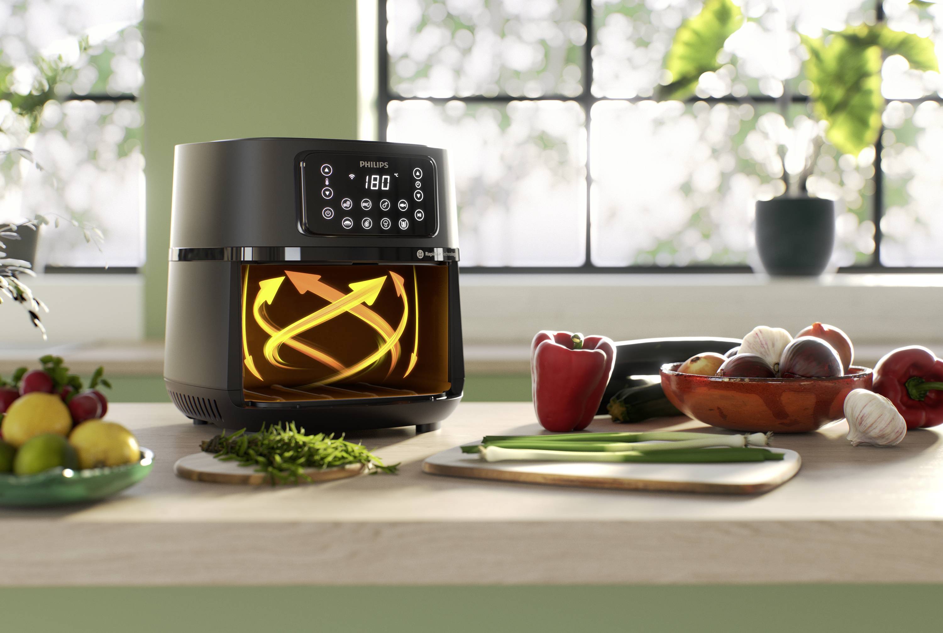 An air fryer on a kitchen worktop, surrounded by fresh vegetables. A display shows 180 degrees.