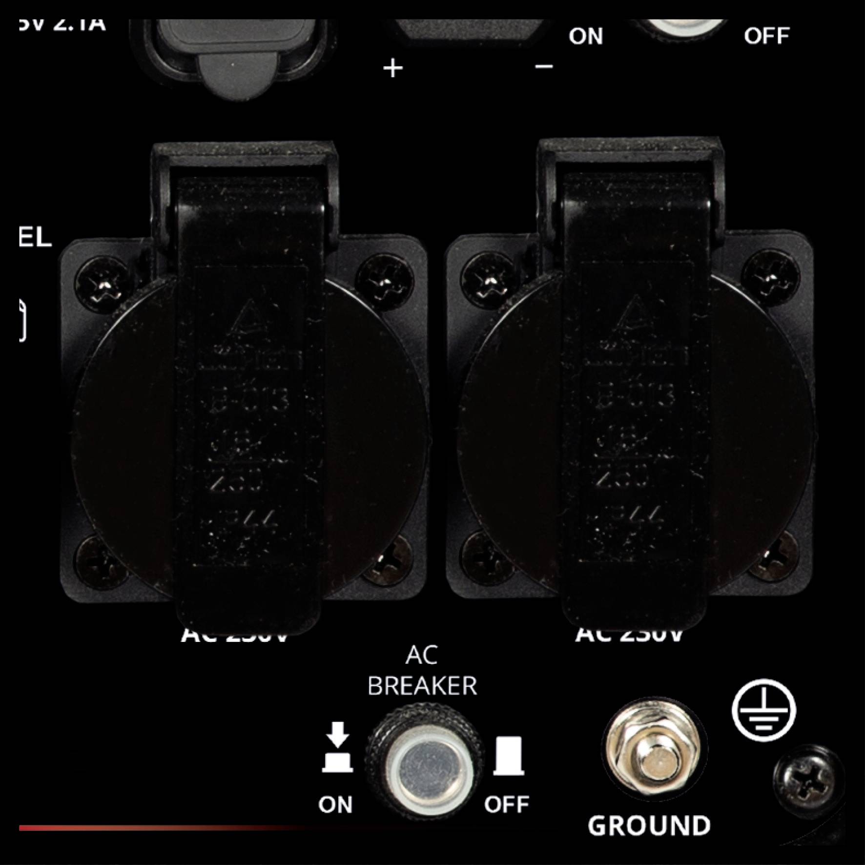 'Two black AC 250V outputs with switches on top. Bottom left, an AC switch, next to it an earth connection.'