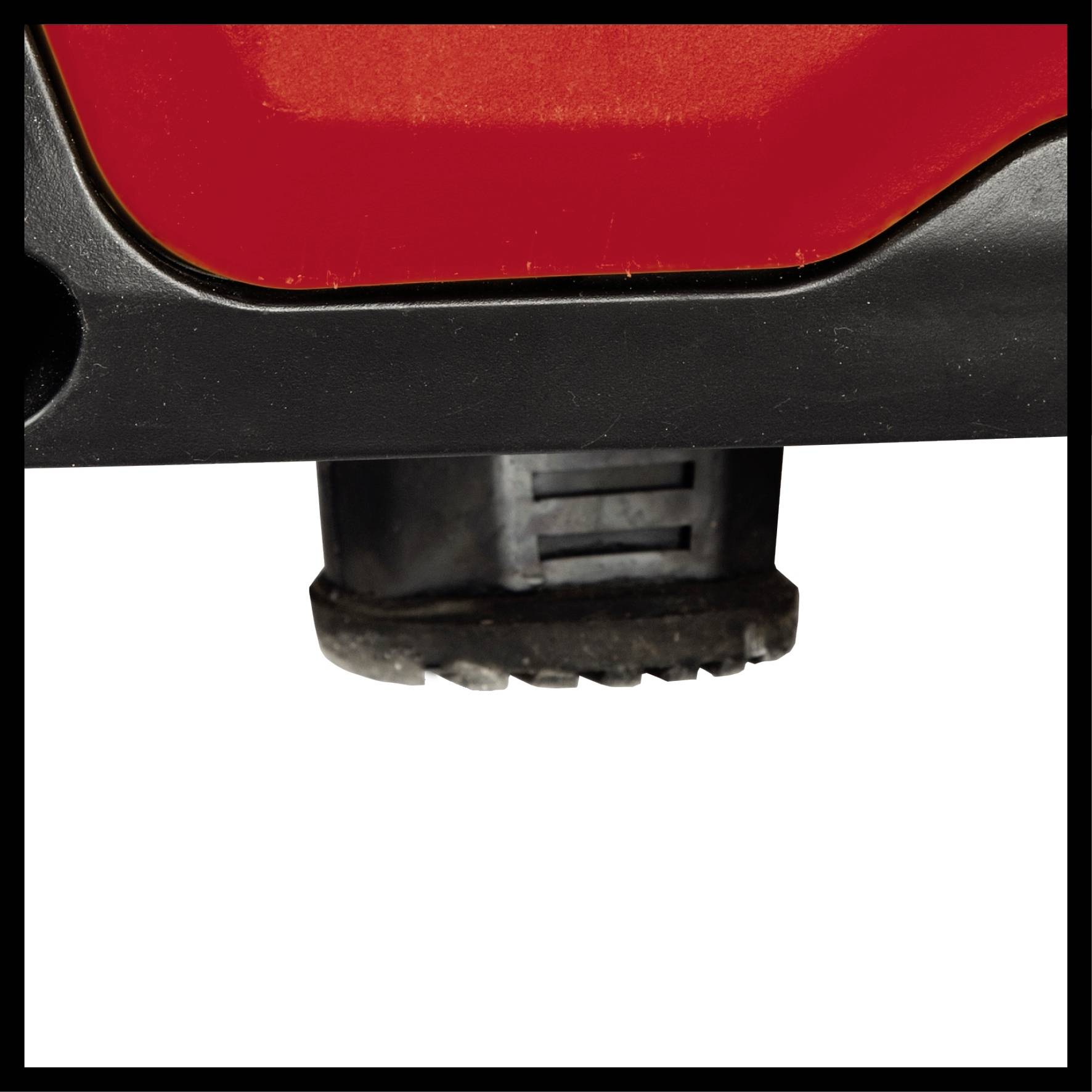 Close-up of a tool, likely an electrical device, with a red and black casing and a serrated blade at the bottom.