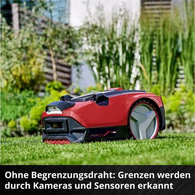 Robotic lawnmower on grass, surrounded by plants. Text: 'Without boundary wire: Boundaries detected by cameras and sensors.'