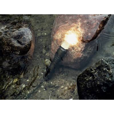 'Underwater torch beaming, lying beside several stones in clear water.'
