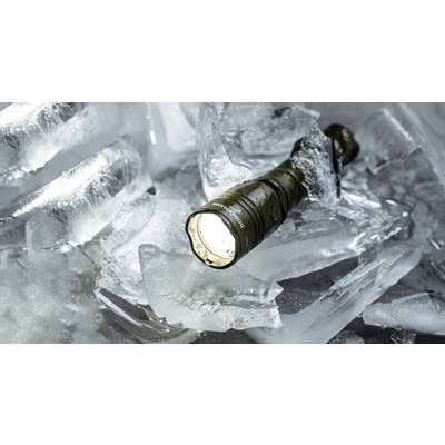 A switched-on torch lies on broken pieces of ice and illuminates the surroundings.
