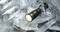 A switched-on torch lies on broken pieces of ice and illuminates the surroundings.