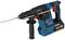 Blue and black electric hammer drill with a red switch and silver drill bit, ready for use.