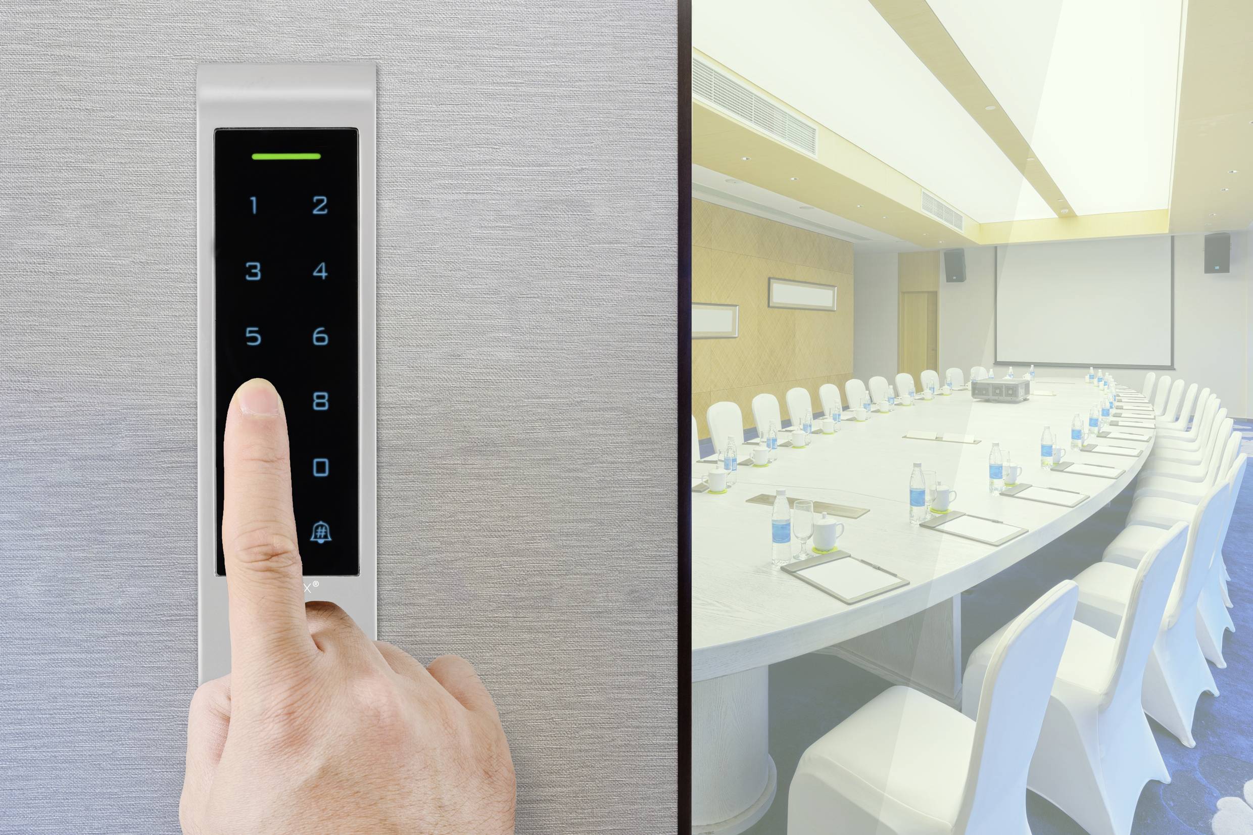 A finger presses a number pad on a door. To the right, an empty conference room with an oval table, chairs, and bottles can be seen.