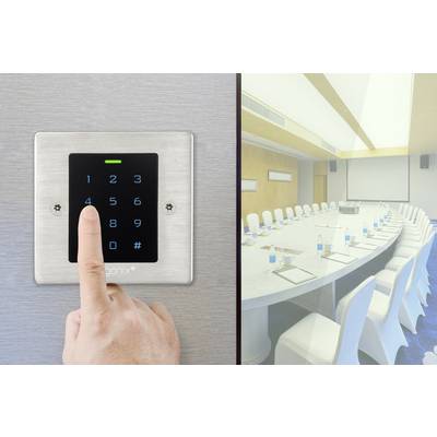 A finger taps on a number lock in front of a conference room with an oval table, surrounded by white chairs.
