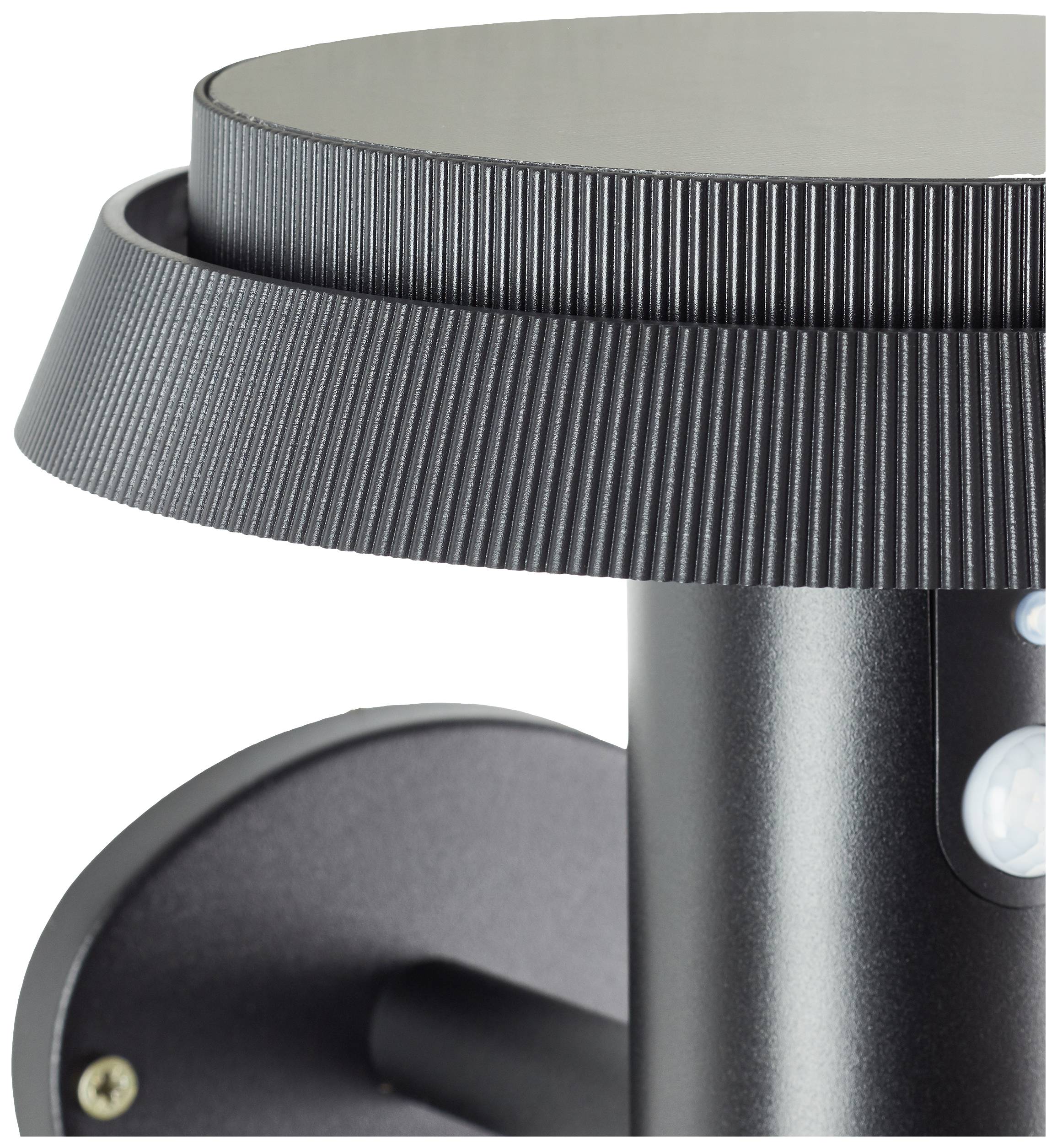 A black wall light with a ribbed shade and cylindrical base, mounted on a round wall bracket.