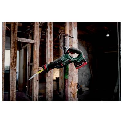 A power saw is attached to a metal pipe amidst a construction site with wooden beams and partially exposed walls. The area appears under renovation.