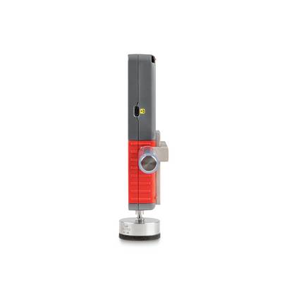 A vertical, electronic device in red and grey with a metal knob in profile view.