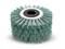 A round brush with greenish bristles and a black hexagonal hole in the centre, suitable for cleaning purposes.