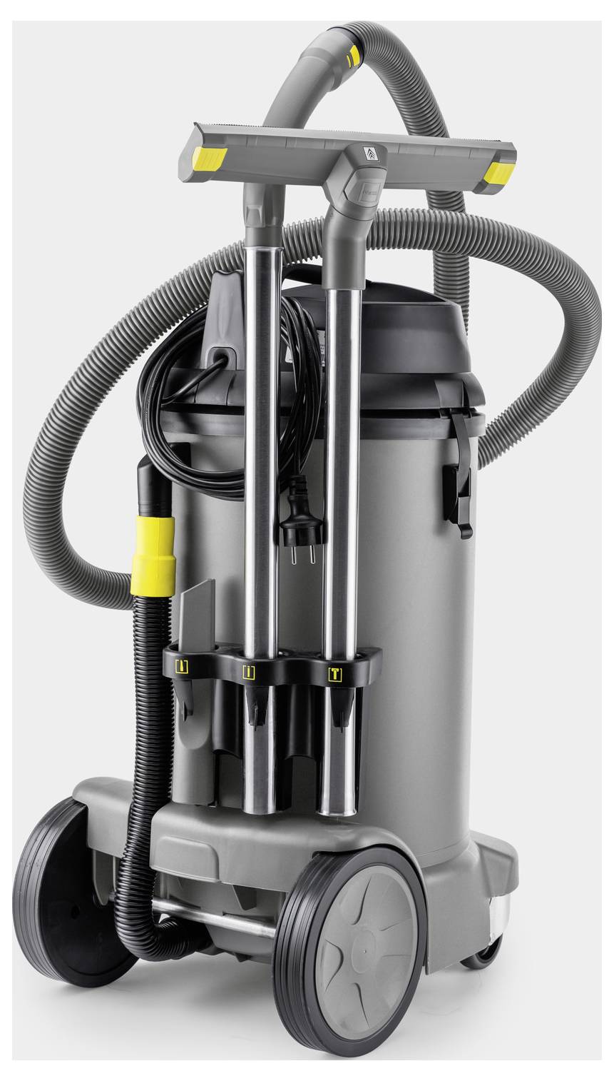 A large industrial vacuum cleaner with multiple hoses and attachments, featuring robust wheels for mobility and a compact design.