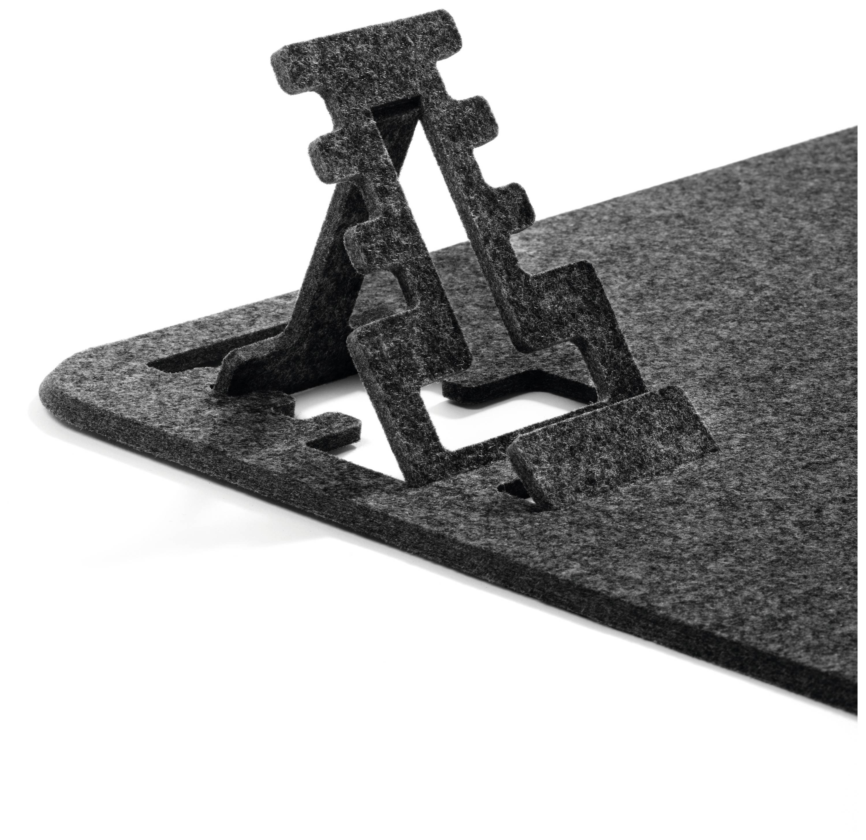 A height-adjustable, modern bookend made of grey felt sits on a flat surface.