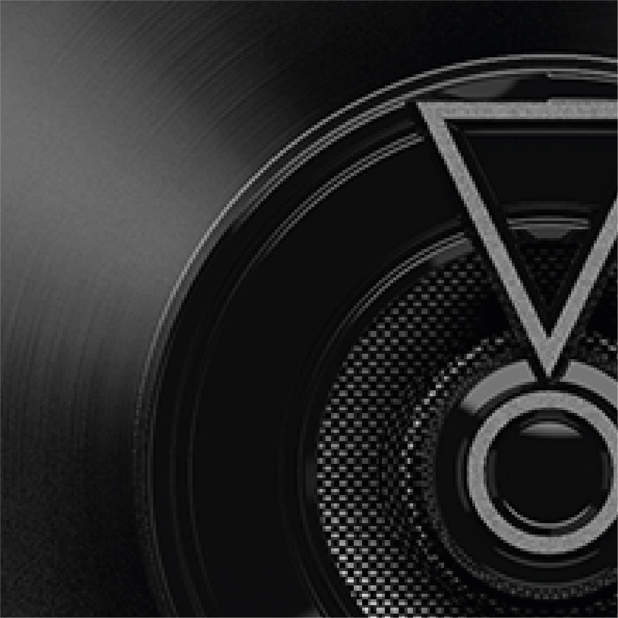 Black vinyl record cover with circular patterns and geometric shapes in the centre.