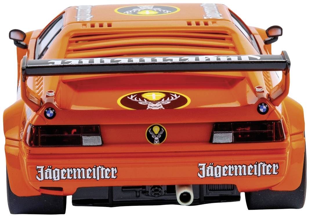 Orange sports car model from behind, with 'Jägermeister' stickers, prominent rear spoiler, and black exhaust pipe.