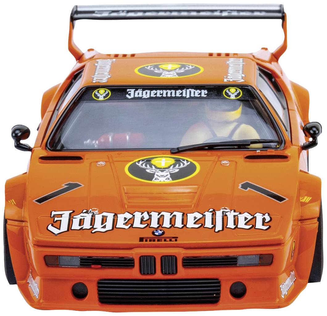 Racing car in Jägermeister livery, photographed from the front. It has a striking orange paint finish, prominent logos, and a large rear spoiler.