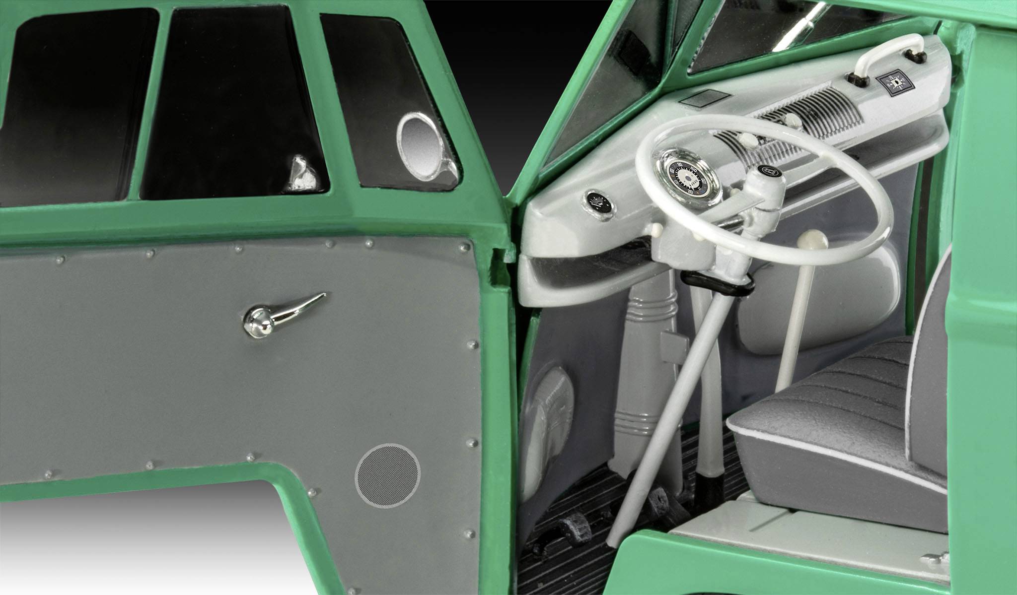 A green minibus with an open driver's compartment, showing the steering wheel, dashboard, and front seat in detail.