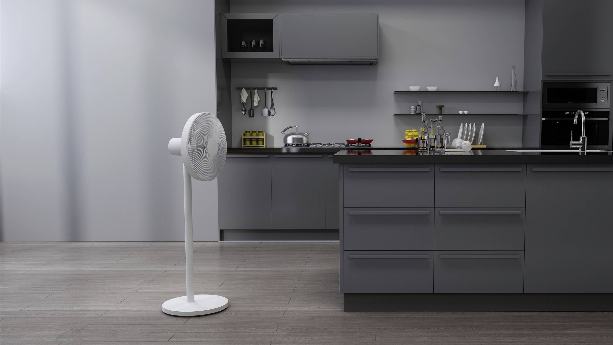 A contemporary kitchen space with grey cupboards and appliances. A pedestal fan is positioned on the floor, to the left of the image.