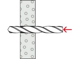 A drill penetrates a dotted material from left to right. A red arrow points to the tip of the drill.