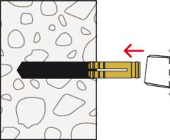 A rawlplug is inserted into a wall and turned clockwise to secure a wall anchor.
