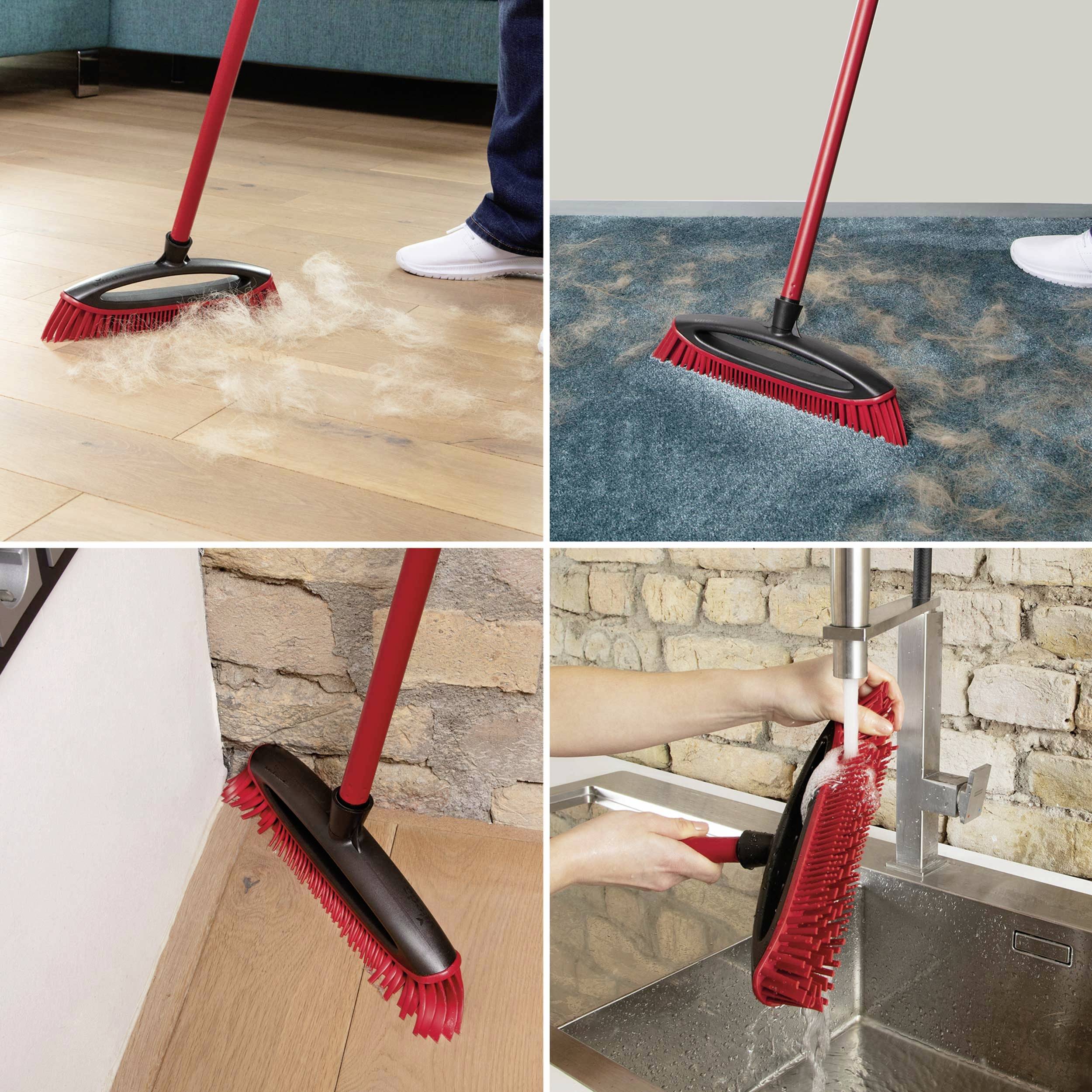 A broom with a red handle sweeps dust from wooden floors and carpets. The broom is also used for cleaning in the kitchen.