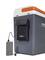 Portable cool box in grey with an orange lid, featuring a USB port and battery bank mounted on the side.