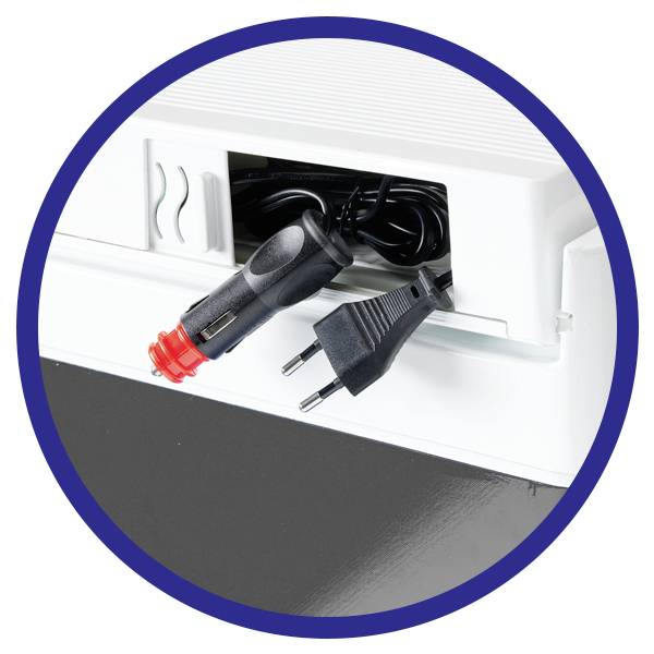 A charger with two adaptor plugs, a black plug adaptor and a red cigarette lighter adaptor, protrudes from a device.