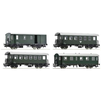 Four green historical railway carriages, each with a different window and door configuration, pictured from the side.