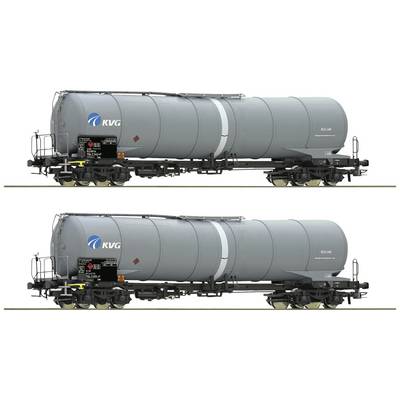 Two silver-grey tanker wagons of the KVG on a railway track, each with safety markings and logos. Both look identical.