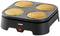 An electric pancake maker with four golden-brown pancakes on the hotplate, ready to be served.