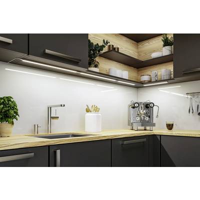 Modern kitchen with dark cupboards, wooden worktops, a coffee machine and a small plant pot beside the sink.