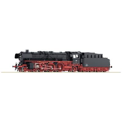 Historic black steam locomotive with red wheels stands on railway track, side detail view, clear focus on the chassis.