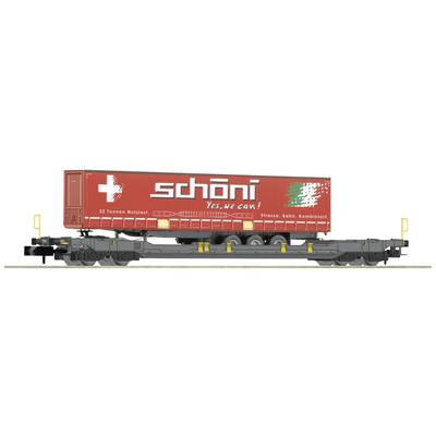 A container on a goods wagon with the text 'schöni: Yes, we can!' and a large white plus sign. Transport and logistics in focus.